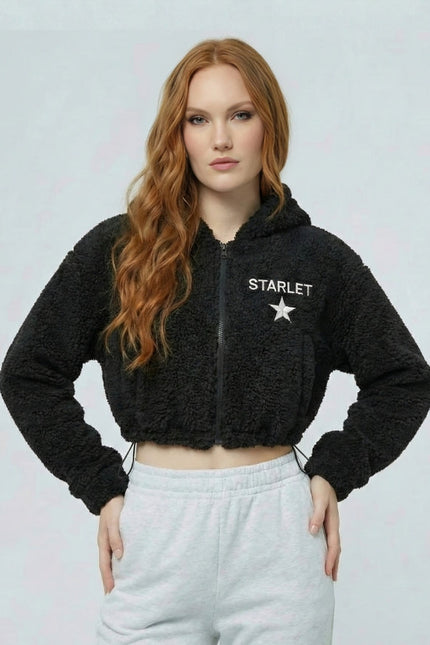 Woman wearing a black 'STARLET' hoodie with a white star logo on a light gray background