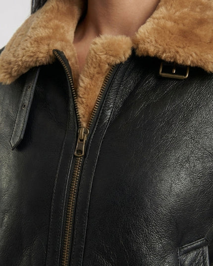 Close-up of a black leather jacket with brown fur lining