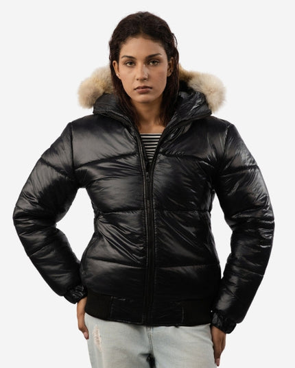 Woman wearing a black puffer jacket with fur hood on a white background