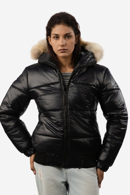 Woman wearing a black puffer jacket with fur hood on a white background