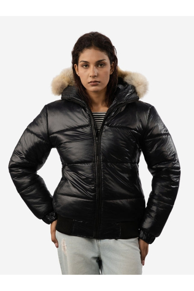 Woman wearing a black puffer jacket with fur hood on a white background