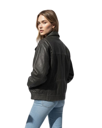 Woman wearing a dark jacket and light blue jeans on a white background