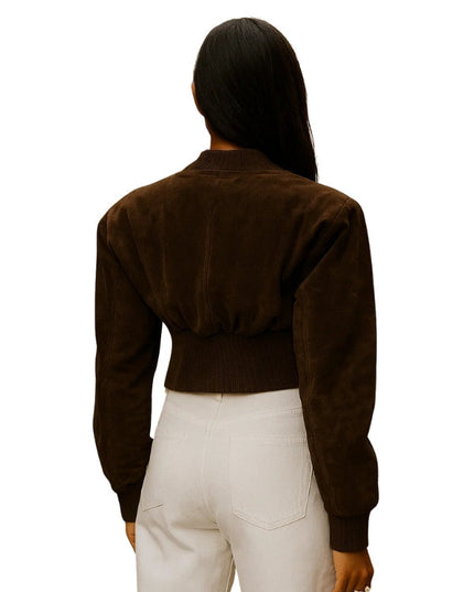 Person wearing a brown jacket and white pants on a white background