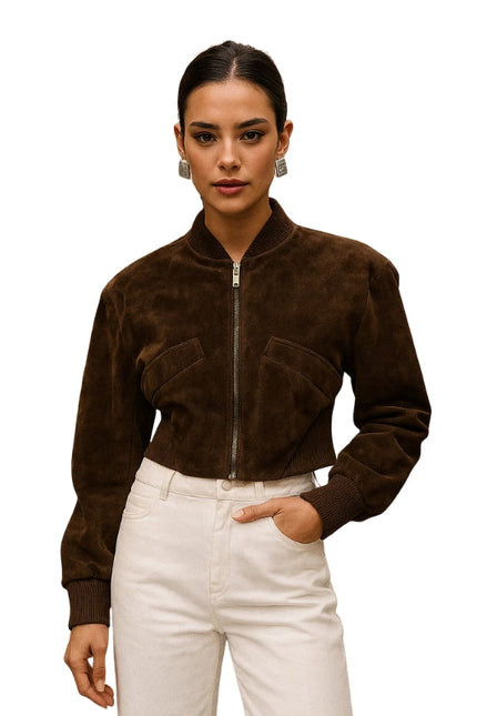 Woman wearing a brown suede jacket and white pants on a white background