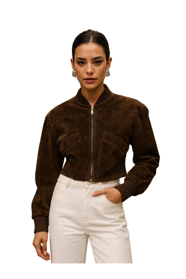 Woman wearing a brown suede jacket and white pants on a white background