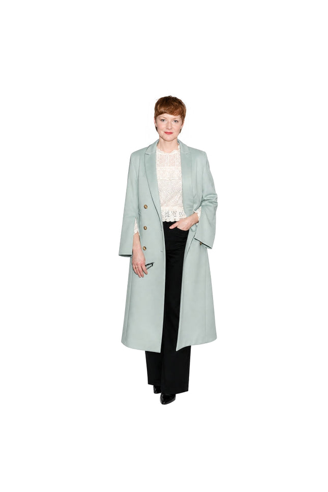 Person wearing a light blue coat on a white background