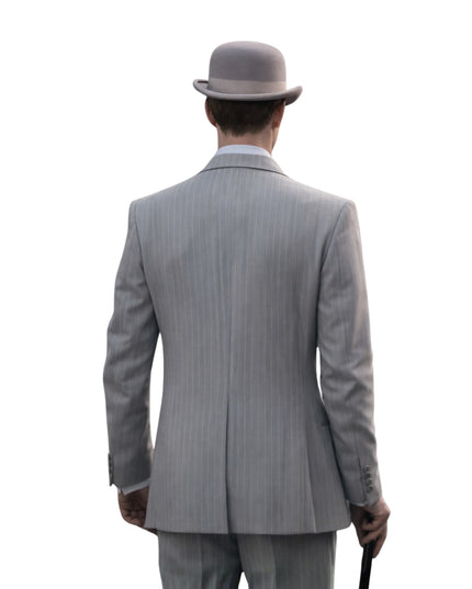 Man wearing a gray pinstripe suit and bowler hat from behind on a white background