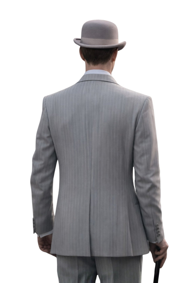 Man wearing a gray pinstripe suit and bowler hat from behind on a white background