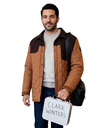 Man holding a suitcase with 'Clark Winters' on it against a white background