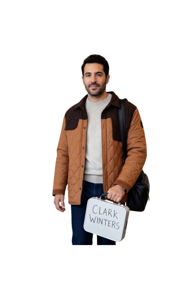 Man holding a suitcase with 'Clark Winters' on it against a white background
