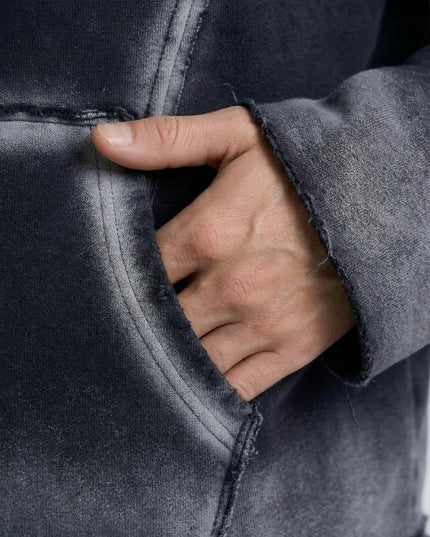 Hand peeking out from a dark gray jacket with a close-up view.