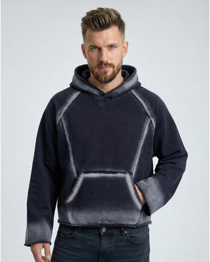 Man wearing a dark gray hoodie with a light gray gradient on a light gray background