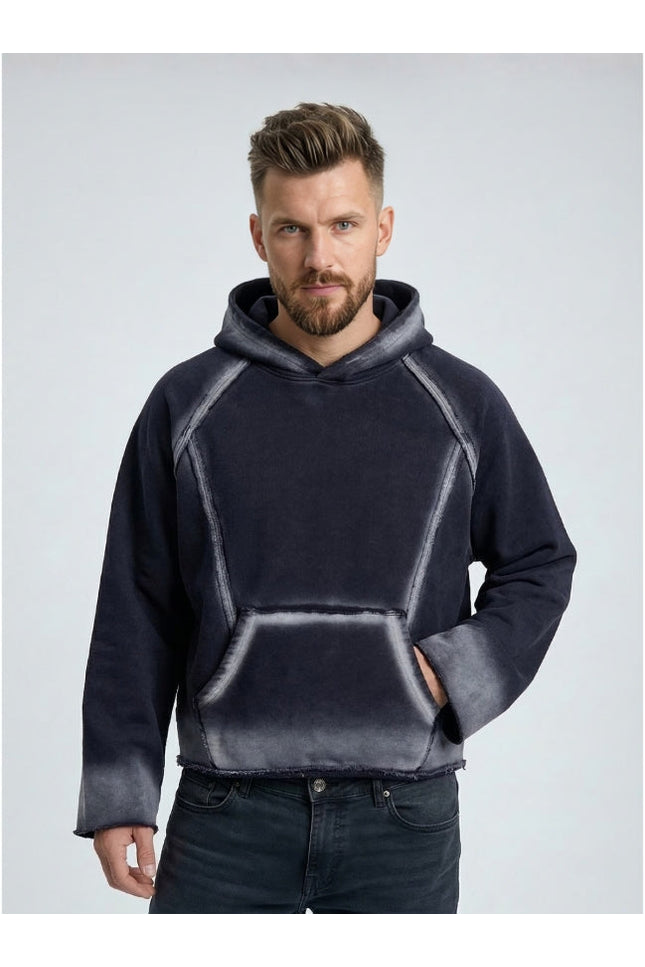 Man wearing a dark gray hoodie with a light gray gradient on a light gray background